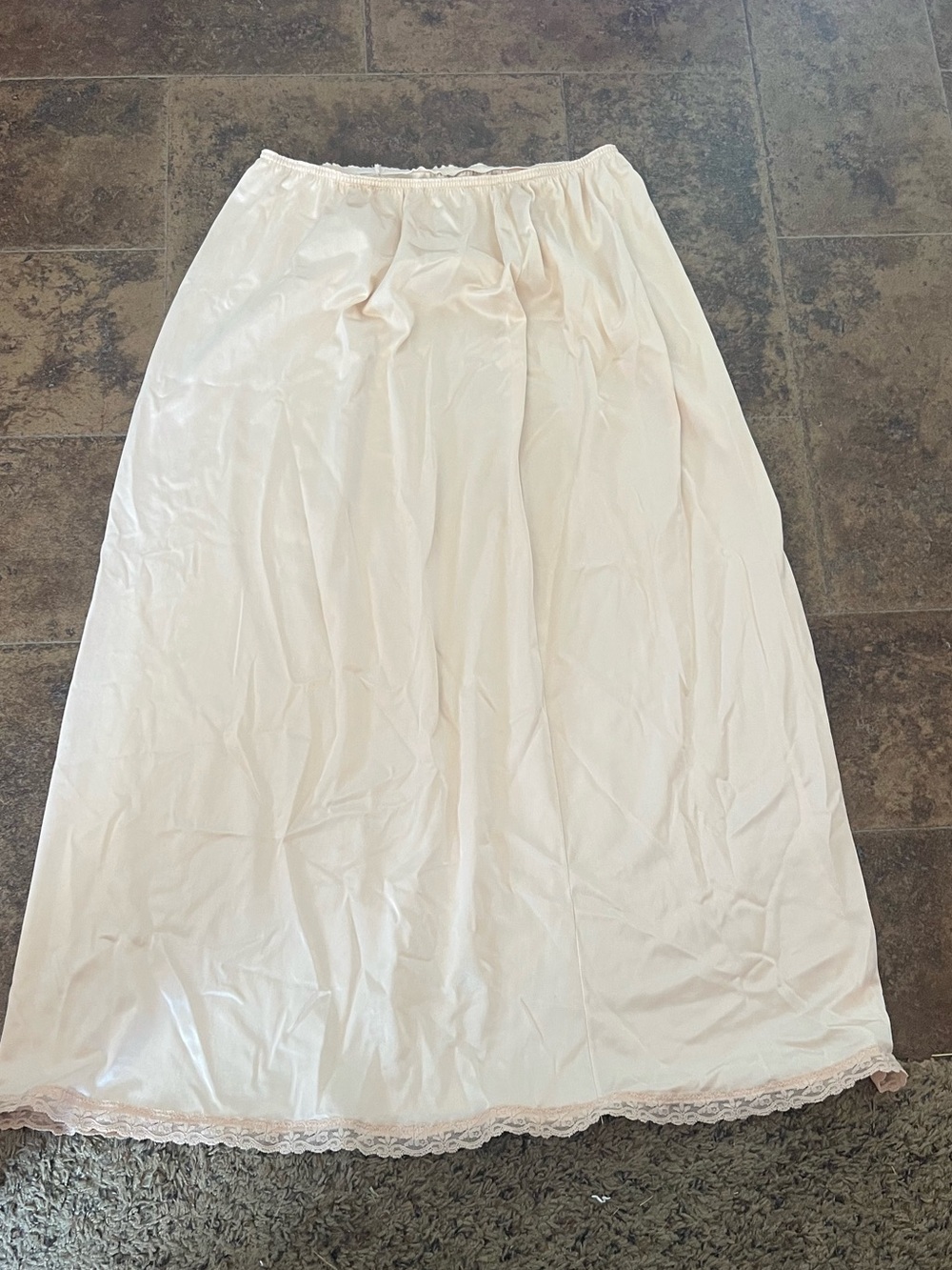 vintage cream-colored nylon half slip features delicate lace trim along the hem